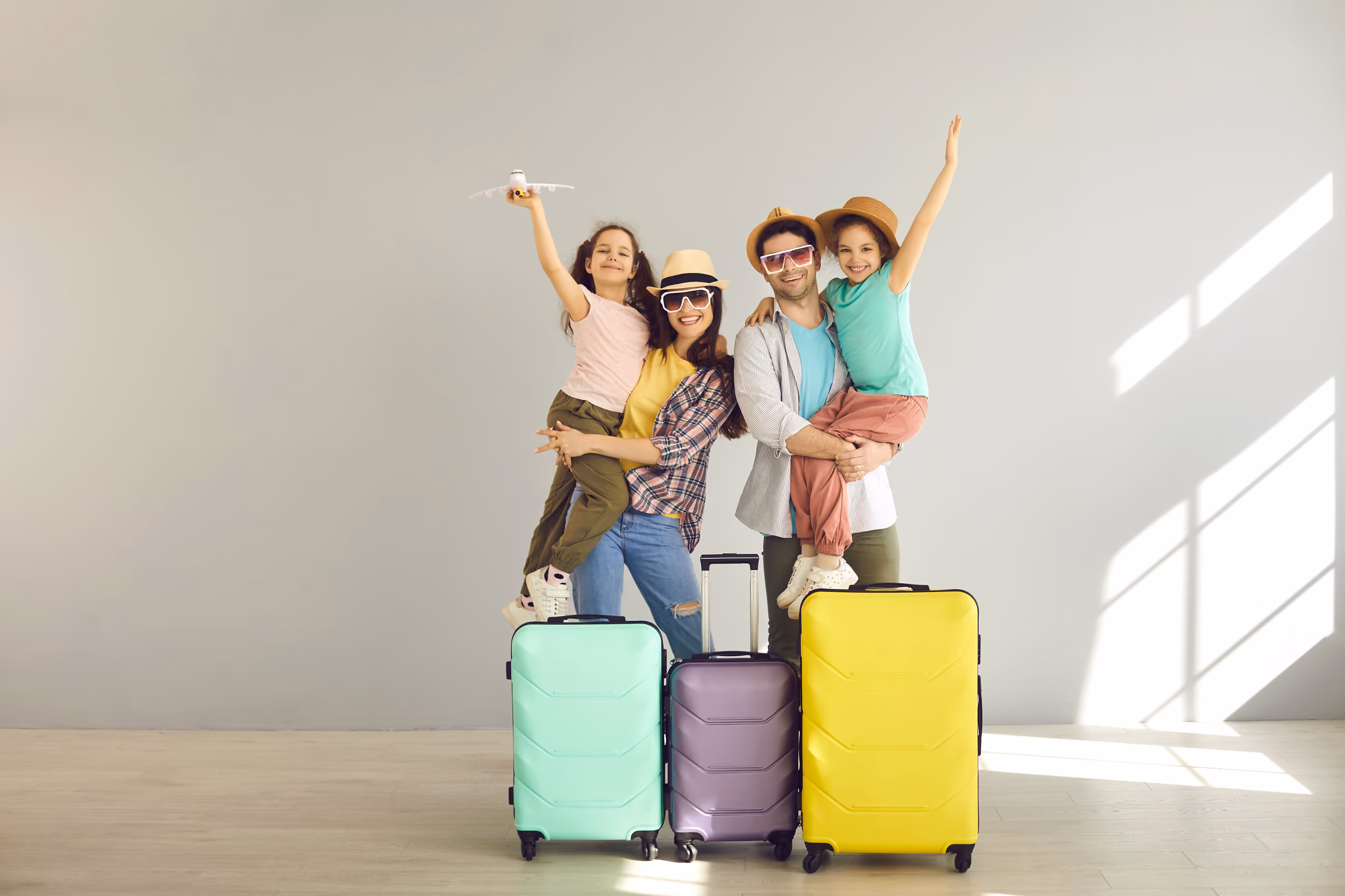 An excited family with suitcases ready to move abroad